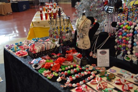 Business owner of Twin Diva Boutique Sarah Parker displays her broad selection of homemade trinkets for her customers to select on December 7th, 2013. During the event’s timespan from 8:00 AM to 4:30 PM, many vendors talked casually with their customers as they passed out business cards and sold their products. “It takes me about 5 minutes to complete each item,” Parker said. “It’s a great stress-reliever for me while the kids are out at school.”