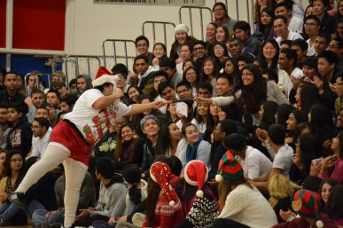Senior Bidisa Mukherjee smiles as she is handed her present, a poster of Justin Bieber. “Even though it wasn’t a class competition this year, I still feel like it brought the school together this holiday season at AHS,” Cordova said. PC: Priscilla Ng