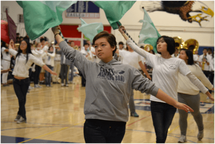 Tanya Komrosky (12) performs with the Color Guard to the marching band’s rendition of “Christmas Carols on Parade.” ASB included many groups and clubs into the winter rally, which helped to increase the crowd’s interest. “The band was really good,” Shing said. “I hope that ASB includes them in more activities in the future.” PC: Priscilla Ng