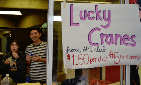      Seniors Lemi Mochinaga and Roger Lee sell cranes on Thursday, February 6.  API club officers all came up with the idea to sell chains of cranes collaboratively. “Cranes are really pretty and decorative,” sophomore Denise Kuo said. “It was a cute way to connect to the Chinese New Year that just passed and also with Valentine’s Day.” // PC: Navy