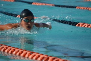 Sophomore Kimya Khayat swims the butterfly at Washington High School during AHS/WHS meet. Though the team has no matching swimsuits or caps yet, the team has remained positive for the rest of the season.  “Swimming at Irvington was actually very fun,” senior Silvia Chen said.  “Sometimes there was no light in the pool, so swimming in the dark was an interesting experience! We didn't get tan!”  PC: Karishma Krishnan