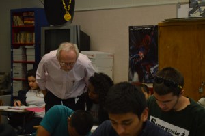 Mr. Toft talks to his fifth period English 12 class about George Orwell’s Animal Farm, while they work on a writing assignment.  Mr. Toft only started teaching Drama four years ago, but he said he spent almost as much time at AHS as at his own home.  “I plan to move, so I won’t be coming back here a lot,” Mr. Toft said. “ It’s strange though because I’ve been in this room [301] since the fall of 1995.”  PC: Caroline Lee