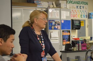 Mrs. Sykes discusses the materials and procedures of a lab with her AP Chemistry students.  Though she has been teaching both Honors and AP Chemistry for many years, when she first arrived at AHS in 1996, she also taught Integrated Science, which included Earth and Physical sciences.  “I started teaching here when the seniors were born, so we are all graduating together,” Mrs. Sykes said. PC: Caroline Lee