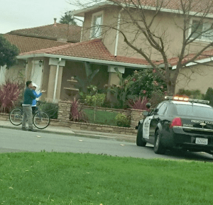 Onlookers watch as the Fremont Police surround the perimeters of the general crime scene.