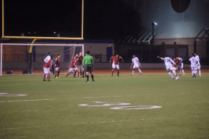 The American defense looks on in anticipation as the Kennedy forward looks to put the ball in the back of the net. The American vs Kennedy game was played on January 9,2015 at Tak Fudenna Stadium where American eventually lost the game 2-1. “Even though we didn’t win as many games as we would have liked, we know that we gave it our all on that field.” varsity soccer player Michael Strauss (12) said. 