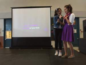 Courtney Cheung (11) and Francesca De Las Alas (12) volunteer to sing in the “Throwback Thursday Karaoke” during lunch. The karaoke event was contingent to the dress up day, called Decades, in which students dressed in outfits from their favorite era.